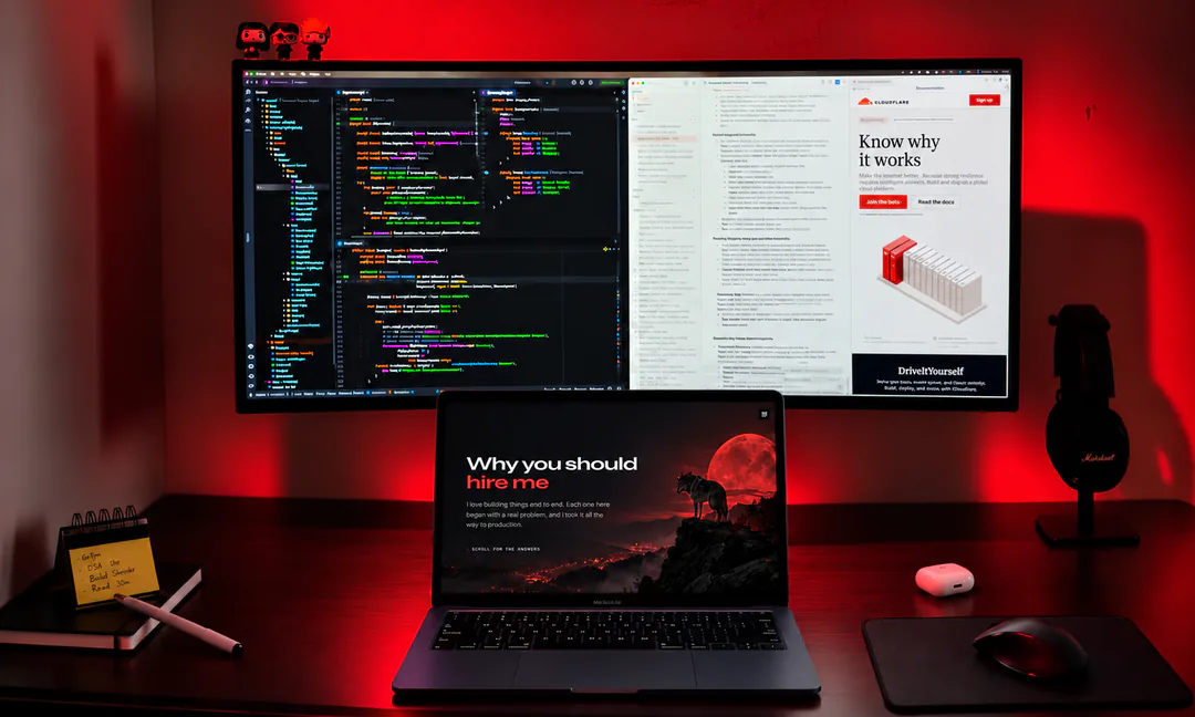 My desk in Pro Max mode: the ultrawide monitor with the laptop open in front of it, showing this page